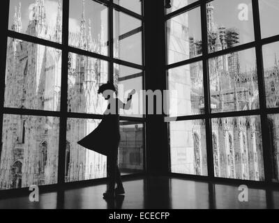 Italy, Lombardy, Milan, Woman dancing in front of duomo Stock Photo