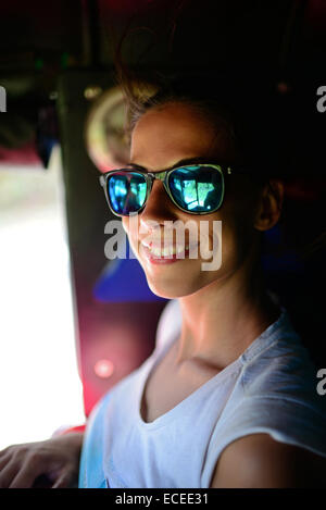 Young woman travels inside a tuk tuk in Sri Lanka Stock Photo