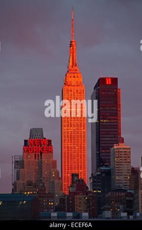 NEW YORK - OCTOBER 19 : Empire state building facade shines at sunset. It was world's tallest building for more than 40 years (f Stock Photo