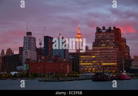 NEW YORK - OCTOBER 19 : Pier 45 and Empire state building facade shines at sunset. It was world's tallest building for more than Stock Photo