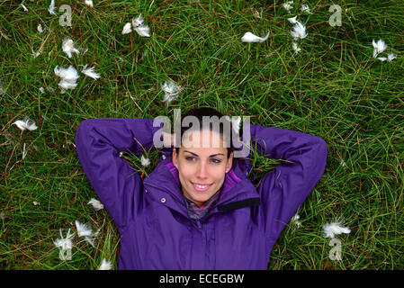 Young woman relaxing in the mountain fields of Kalsoy, Faroe Islands Stock Photo