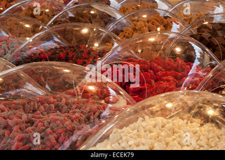 Varieties of Pick n Mix sweets on sale, boiled, fizzy, foam, jelly, chewy retro, chocolate candy covered in clear plastic domes Southport, Merseyside, Stock Photo