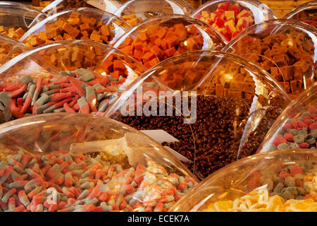 Varieties of Pick n Mix sweets on sale, boiled, fizzy, foam, jelly, chewy retro, chocolate candy covered in clear plastic domes Southport, Merseyside, Stock Photo