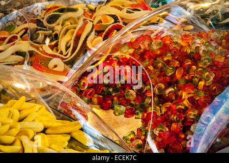Varieties of Pick n Mix sweets on sale, boiled, fizzy, foam, jelly, chewy retro, chocolate candy covered in clear plastic domes Southport, Merseyside, Stock Photo
