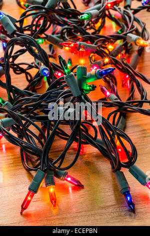 String of multicolor Christmas lights with green wiring. Stock Photo