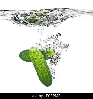 green cucumbers dropped into water isolated on white Stock Photo