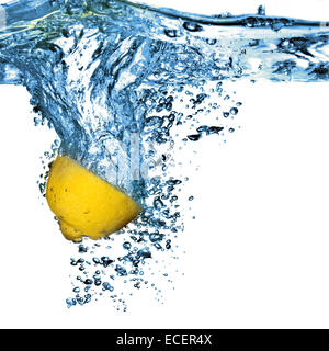 Fresh lemon dropped into water with bubbles isolated on white Stock Photo