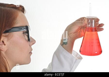 Researcher holding a glass beaker in a lab Stock Photo