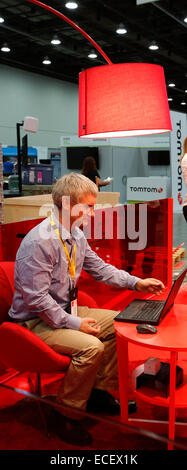 Detroit, Michigan - A participant in the Intelligent Transport Systems World Congress works on a laptop in the exhibit hall. Stock Photo