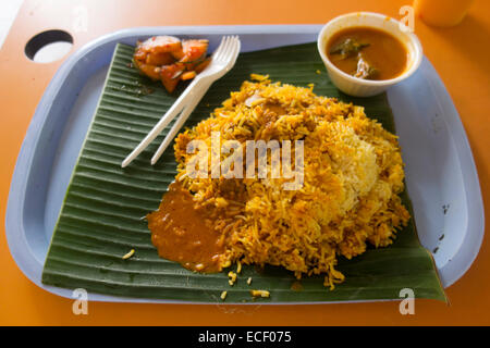 Indian spicy lamb Biryani curry and rice meal on a banana leaf Stock Photo