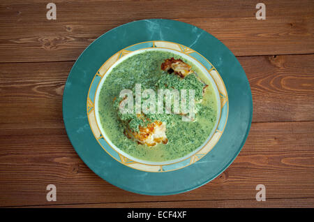 Merluza en salsa verde - fried fish with green sauce Stock Photo