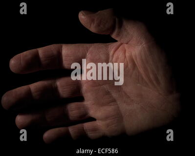 Man's hand on black background Stock Photo