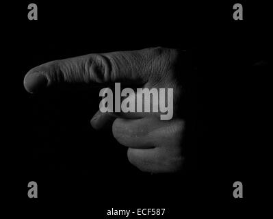 Man's hand pointing on black background Stock Photo