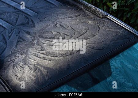 Hoar frost or soft rime on a cold winter day on vehicle in West Lancashire.  Water vapour condensed on the metal roof and glass forming frost patterns. Window frost often makes elaborate patterns as the crystal growth is strongly influenced by the window surface.  Scratches, residual soap streaks, etc., can all change the way the crystals nucleate and grow. Stock Photo
