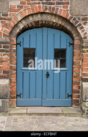 Blue basement door. Shot from Viborg, Denmark Stock Photo