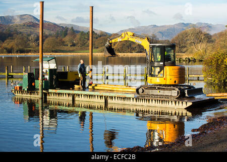 A barge from a jetty construction company loading posts on Lake windermere in Ambleside, Lake District, UK. Stock Photo