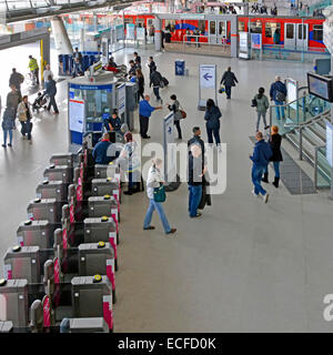 Stratford London railway station interior view with Oyster Card ticket barriers and DLR train beyond Newham East London England UK Stock Photo