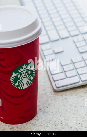 Hurricane Utah - November 29 : photo of a holiday Starbucks cup next to a computer keyboard, November 29 2014 in Hurricane, Utah Stock Photo