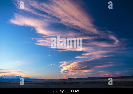 A Chinook arch sweeps across the southern Alberta Prairies near Pincher Creek  Wind Turbines dot the hillsides beneath the cloud Stock Photo