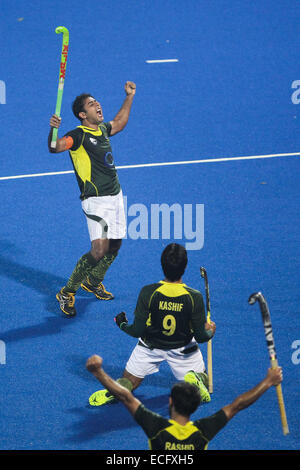 Bhubaneswar. 13th Dec, 2014. Pakistan hockey players Muhammad Imran (top), Syed Shah (C) and Rashid Mehmood celebrate after winning their semifinal match against India at Hero Hockey Champions Trophy 2014 match at Kalinga Stadium in Bhubaneswar on December 13, 2014. Pakistan won 4-3. © Zheng Huansong/Xinhua/Alamy Live News Stock Photo