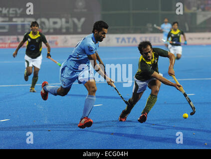 Bhubaneswar, India. 13th Dec, 2014. Dharamvir Singh (front L) of India fights for the ball against a Pakistani defender during the semifinal match of the Hero Hockey Champions Trophy 2014 match in Bhubaneswar, India, Dec. 13, 2014. Pakistan won 4-3 to enter the final. © Partha Sarkar/Xinhua/Alamy Live News Stock Photo