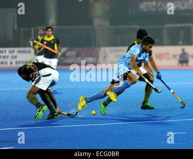 Bhubaneswar, India. 13th Dec, 2014. Nikin C. Thimmaiah (R front) of India dribbles past Pakistani defenders during the semifinal match of the Hero Hockey Champions Trophy 2014 match in Bhubaneswar, India, Dec. 13, 2014. Pakistan won 4-3 to enter the final. © Partha Sarkar/Xinhua/Alamy Live News Stock Photo