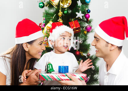 indian with Parents with child Christmas Festival Surprise gift Stock Photo