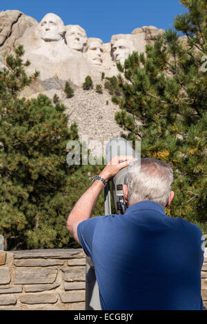 Senior Male Tourist,Viewing  Sculptured Faces with Telescope,  Mount Rushmore National Memorial, SD, USA Stock Photo