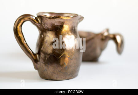 Set of Gold Handmade Clay Vessels on White Background Stock Photo