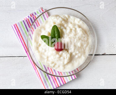 Rice pudding with mint and raspberry. Stock Photo