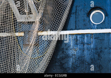 Window of the ship and hanging down networks, close up Stock Photo