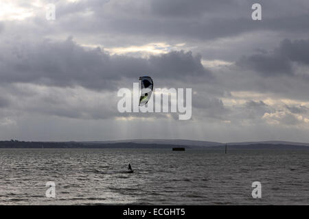 Solent, Hampshire, UK. 14th Dec, 2014. Calshot on the Solent, Hampshire, UK. Kite surfers took to the stormy waters of the Solent taking advantage of the strong winds blowing along the south coast of England today. Credit:  Julia Gavin UK/Alamy Live News Stock Photo