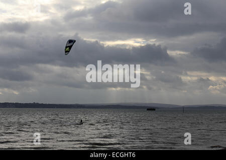 Solent, Hampshire, UK. 14th Dec, 2014. Calshot on the Solent, Hampshire, UK. Kite surfers took to the stormy waters of the Solent taking advantage of the strong winds blowing along the south coast of England today. Credit:  Julia Gavin UK/Alamy Live News Stock Photo