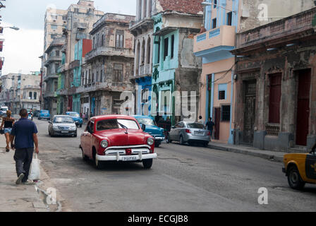 Crumbling buildings and vintage American cars used as taxis are a common sight in the Central district of Havana Stock Photo