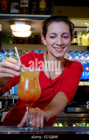 Pretty female bartender serving cocktail Stock Photo