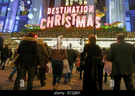 Christmas shoppers in Oxford Street, London cross road in front of Selfridges department store Stock Photo