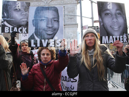 New York, USA. 13th December, 2014. Kristin Reed (from left), Caron Atlas and Julia Hillman Craig marched from Washington Square Park in lower Manhattan during Millions March NYC on December 13, 2014. The mass protest denounced the use of excessive force by police officers on African American men and the not guilty verdict delivered in the Eric Garner case in Staten Island, New York. Credit:  SEAN DRAKES/Alamy Live News Stock Photo