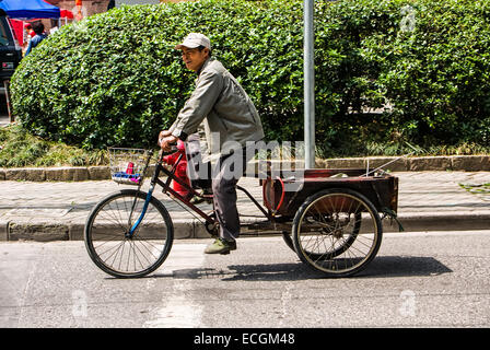 Man Riding a 3 Wheel Bike in Shanghai China Stock Photo