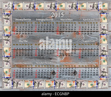 calendar for 2015 year in the American dollars' frame on the wooden board Stock Photo