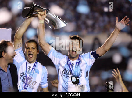 Avellaneda, Argentina. 14th Dec, 2014. Players Diego Milito (R) and Sebastian Saja (C) of Racing Club celebrate with the trophy at the end of the Final match against Godoy Cruz of Argentinean Soccer First Division at Presidente Peron Stadium, in Avellaneda City, 20km from Buenos Aires City, Argentina, on Dec. 14, 2014. © Martin Zabala/Xinhua/Alamy Live News Stock Photo