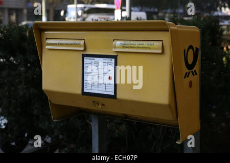 berlin yellow post mailbox Stock Photo