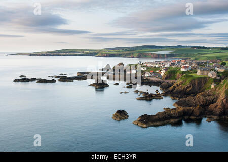 Fishing village of St Abbs on the east coast, town of Eyemouth behind at left, Berwickshire, Scotland, United Kingdom Stock Photo