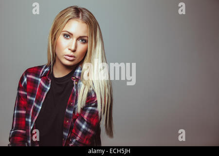 Portrait of stunning young woman wearing shirt looking at camera. Copyspace. Stock Photo
