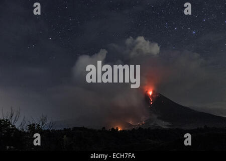 Karo, North Sumatra, Indonesia. 14th Dec, 2014. KARO, INDONESIA - DESEMBER 14: A view of spewing pyroclastic flow from Mount Sinabung volcano eruption seen from Tiga Pancur village on December 14, 2014 in Karo district, North Sumatra, Indonesia. Credit:  Sijori Images/ZUMA Wire/Alamy Live News Stock Photo