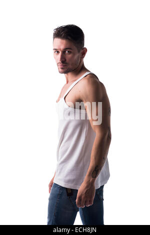 Handsome athletic man with tank top and jeans looking at camera, isolated on white Stock Photo