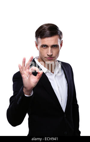 Young confident businessman gesturing OK sign over white background Stock Photo