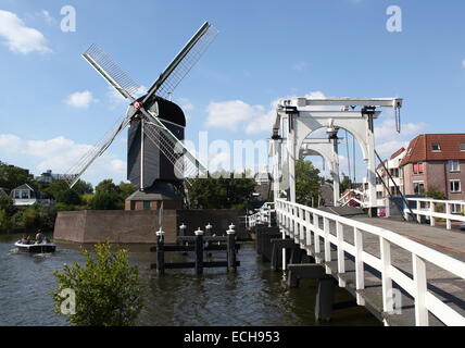 17th century post mill 'De Put' at Galgewater canal in Leiden, Netherlands with Rembrandt bridge on the right. (Modern replicas) Stock Photo