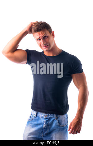 Muscular young man unsure or confused, scratching head with finger, looking up, isolated Stock Photo