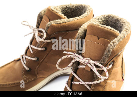 Close up of a pair of ladies women's leather warm fur-lined lace-up winter boots isolated on a white background. UK Stock Photo