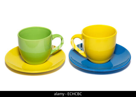 Colored teacups and saucers isolated on white. Stock Photo